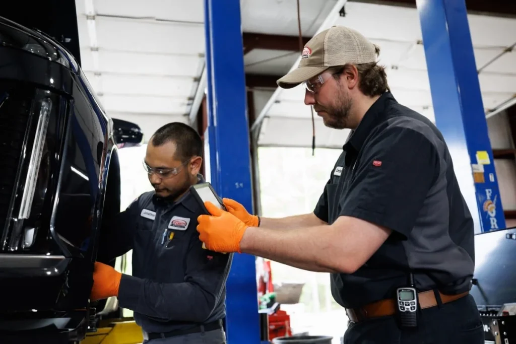 Harrell’s technicians working together on a vehicle